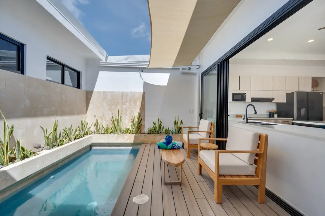 Tamawalk pool, with crystal-clear water, outdoor furniture, a planter to decorate the poolside, and an elegant pergola.